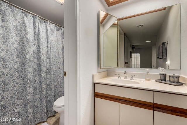 10410 N Cave Creek Rd Unit 2030, Phoenix, AZ 85020 - full bathroom featuring toilet, vanity, tile patterned floors, ceiling fan, and a shower with shower curtain