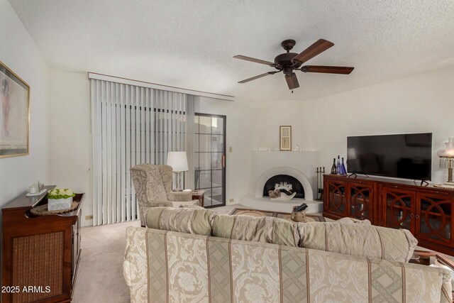 10410 N Cave Creek Rd Unit 2030, Phoenix, AZ 85020 - carpeted living room with a fireplace with raised hearth, ceiling fan, and a textured ceiling