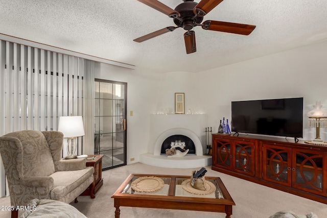 10410 N Cave Creek Rd Unit 2030, Phoenix, AZ 85020 - living room featuring carpet flooring, a textured ceiling, a fireplace with raised hearth, and ceiling fan