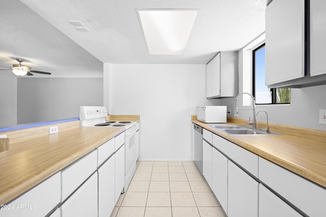 kitchen featuring a sink, white appliances, white cabinetry, and light countertops