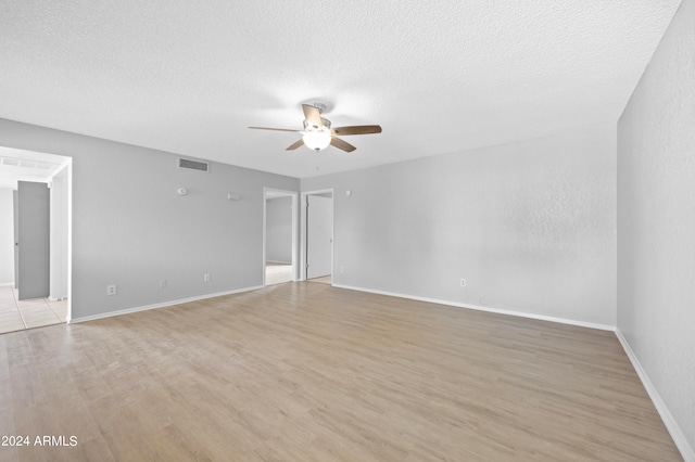 unfurnished room featuring ceiling fan, hardwood / wood-style flooring, and a textured ceiling