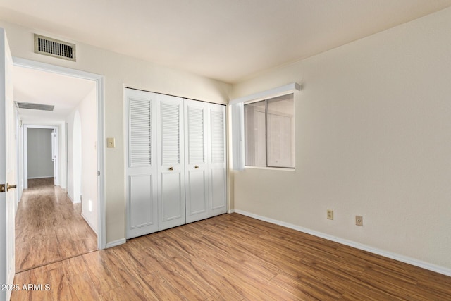 2164 S Estrella Cir, Mesa, AZ 85202 - unfurnished bedroom featuring light wood-style flooring and a closet