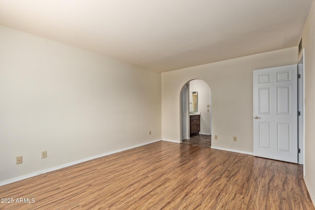 2164 S Estrella Cir, Mesa, AZ 85202 - empty room featuring wood finished floors and arched walkways
