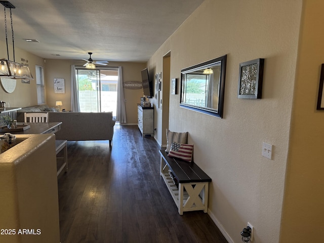 corridor featuring dark wood-style flooring, baseboards, and visible vents