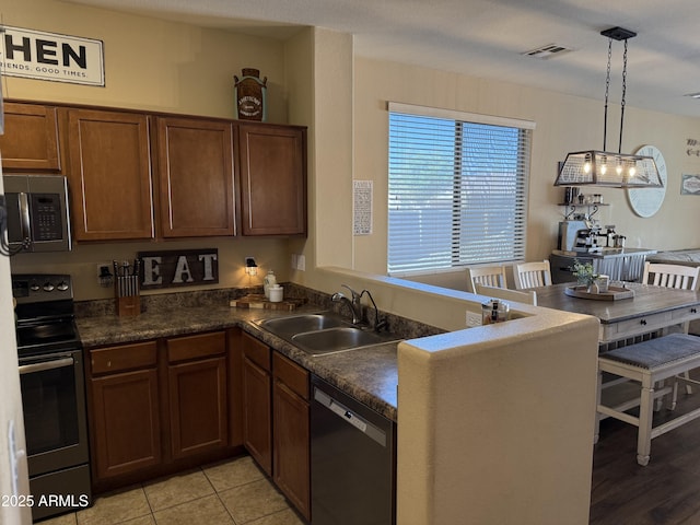 kitchen with visible vents, stainless steel microwave, a sink, electric range oven, and dishwashing machine