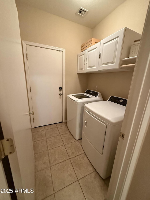 laundry room with cabinet space, visible vents, independent washer and dryer, and light tile patterned floors