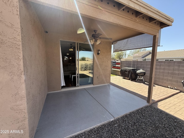 view of patio / terrace featuring fence, area for grilling, and a ceiling fan