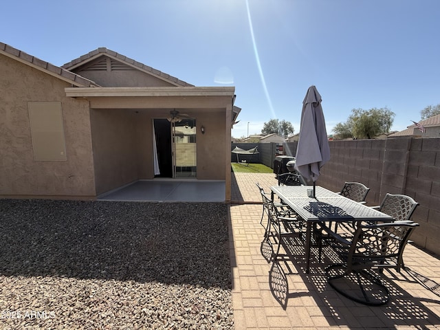 view of patio featuring ceiling fan, fence, and outdoor dining space