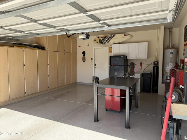 garage with a garage door opener, freestanding refrigerator, and gas water heater