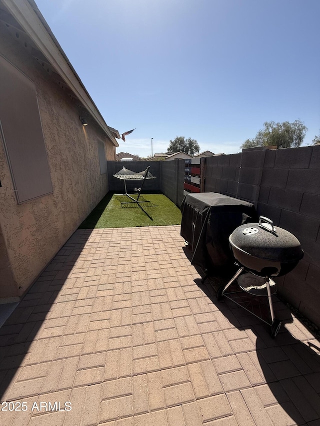 view of patio featuring a fenced backyard and grilling area