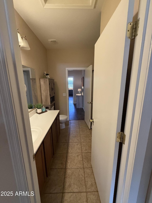 bathroom featuring visible vents, toilet, tile patterned flooring, and vanity