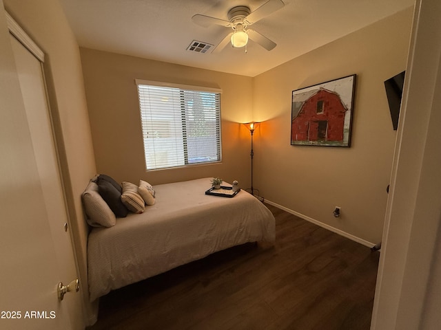 bedroom with dark wood finished floors, baseboards, visible vents, and a ceiling fan