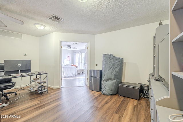 office space with hardwood / wood-style floors and a textured ceiling