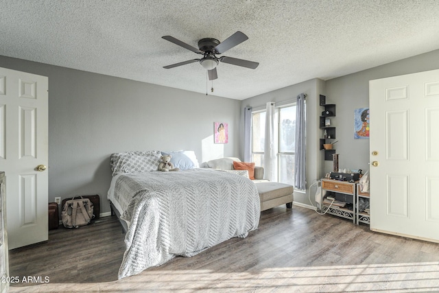 bedroom with ceiling fan, a textured ceiling, and hardwood / wood-style flooring