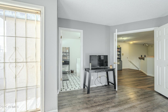 interior space featuring dark hardwood / wood-style floors and a textured ceiling