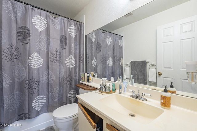 full bathroom with vanity, shower / tub combo, and toilet