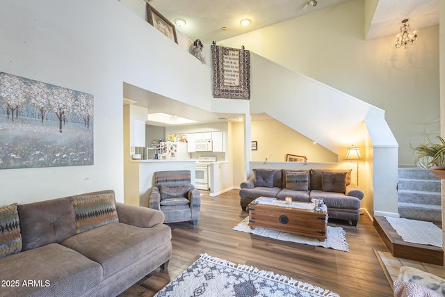 living room with hardwood / wood-style flooring and high vaulted ceiling