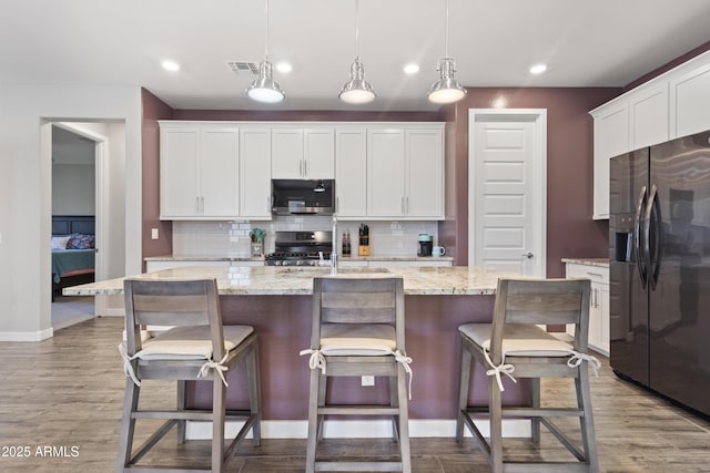 10165 E Gamma Ave, Mesa, AZ 85212 - kitchen featuring refrigerator with ice dispenser, stainless steel microwave, range, backsplash, and recessed lighting
