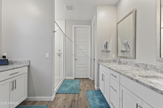 10165 E Gamma Ave, Mesa, AZ 85212 - bathroom featuring double vanity, a stall shower, and wood finished floors