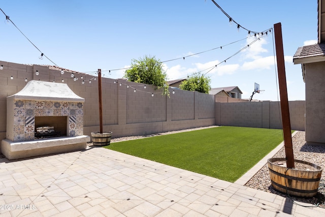 10165 E Gamma Ave, Mesa, AZ 85212 - fenced backyard featuring exterior fireplace and a patio area