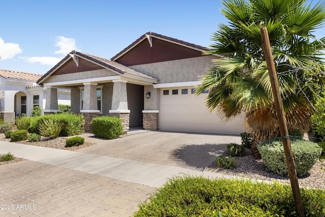10165 E Gamma Ave, Mesa, AZ 85212 - view of front of house with stucco siding, driveway, an attached garage, stone siding, and a tiled roof