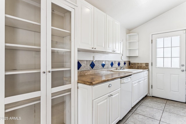 kitchen with white dishwasher, white cabinetry, decorative backsplash, sink, and lofted ceiling