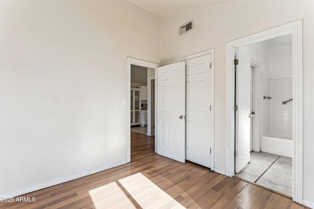 unfurnished bedroom featuring hardwood / wood-style flooring and a closet