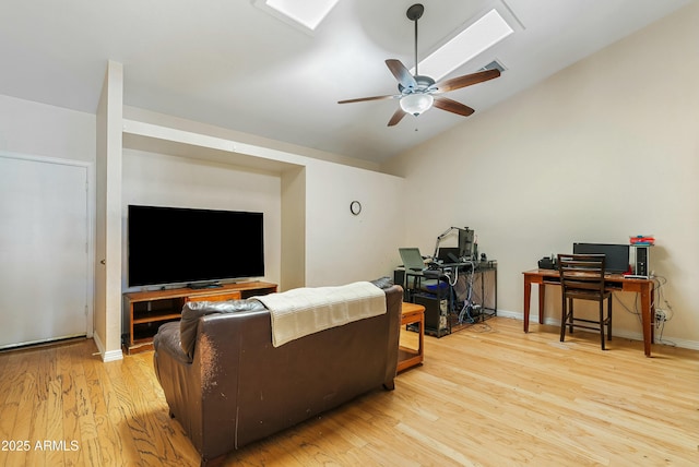 living room with ceiling fan, lofted ceiling, and light wood-type flooring