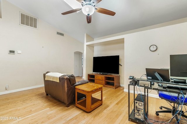 living room with hardwood / wood-style floors, vaulted ceiling, and ceiling fan