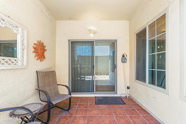 view of exterior entry with a patio