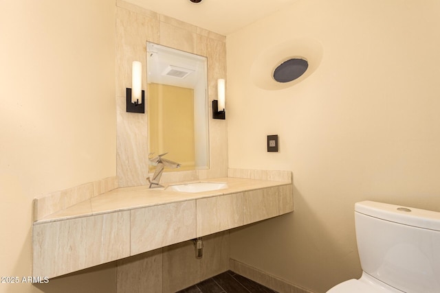 bathroom featuring sink and toilet