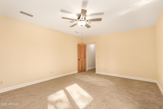 spare room featuring ceiling fan and carpet