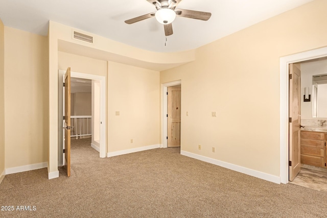 unfurnished bedroom with ceiling fan, connected bathroom, and light carpet