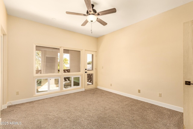 spare room featuring carpet floors and ceiling fan