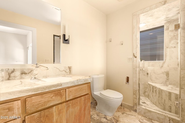 bathroom with toilet, a shower with shower door, and vanity