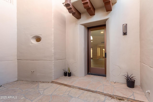 entrance to property featuring a patio area