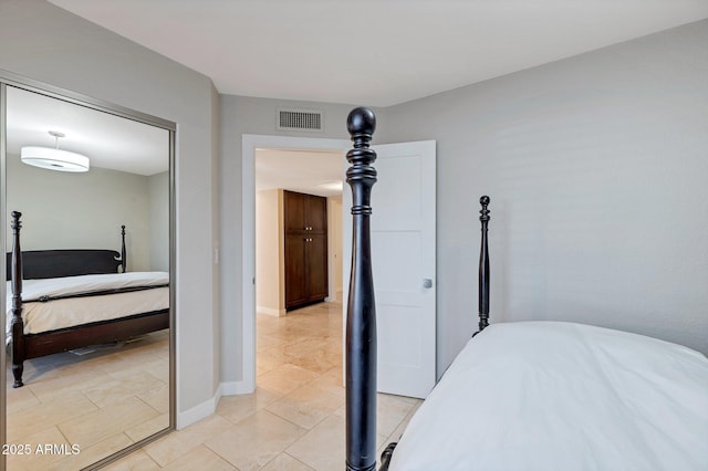 bedroom with light tile patterned flooring and a closet