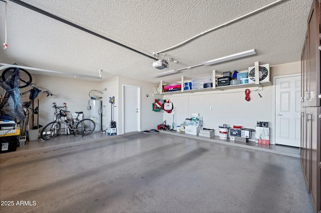 garage with a garage door opener and electric water heater