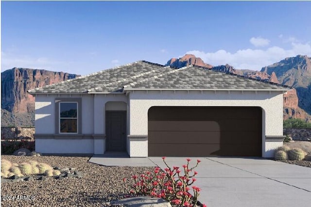 view of front of house with a garage and a mountain view