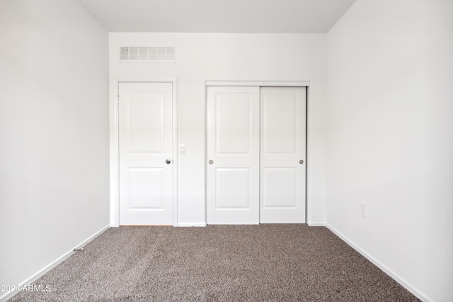 unfurnished bedroom featuring a closet and carpet