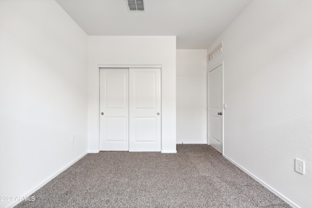 unfurnished bedroom featuring a closet and carpet