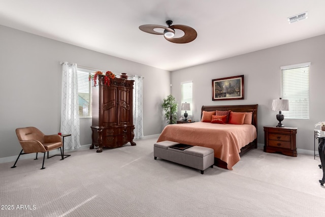 carpeted bedroom with a ceiling fan, visible vents, and baseboards