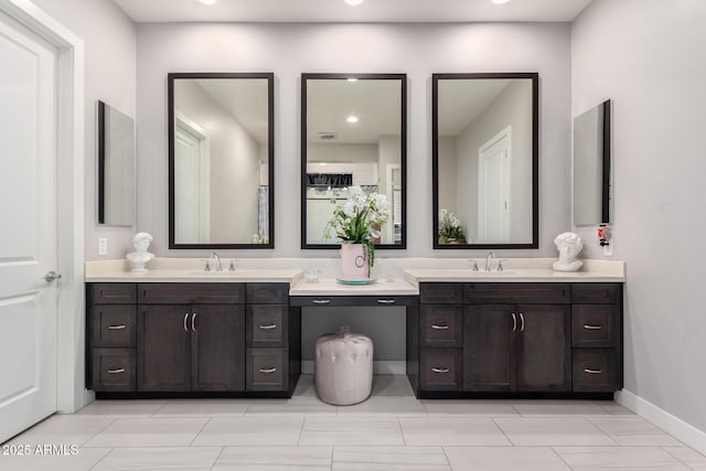 bathroom featuring vanity and baseboards