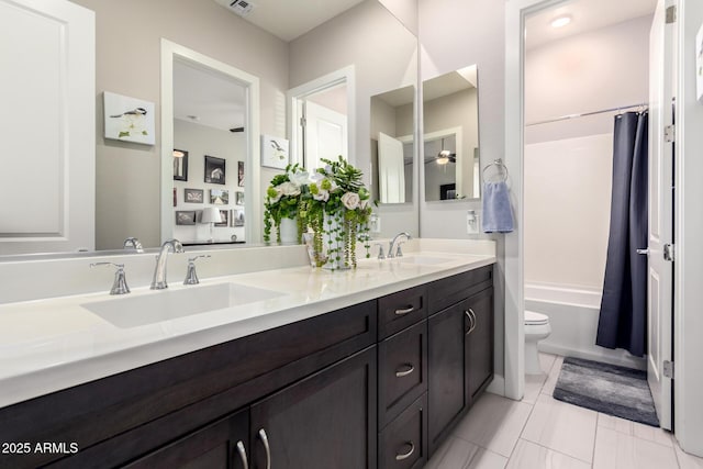 full bath featuring toilet, shower / bath combination with curtain, double vanity, and a sink