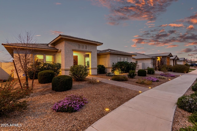 prairie-style home featuring stucco siding