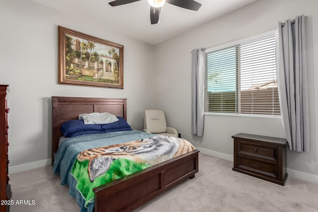 bedroom with light colored carpet, ceiling fan, and baseboards