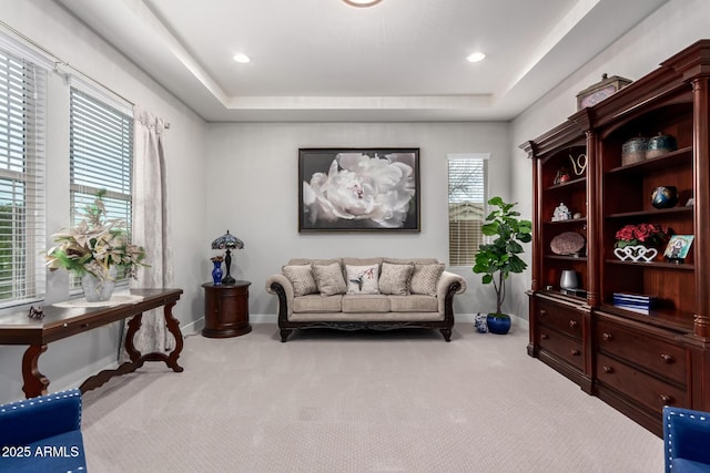 sitting room with carpet flooring, a wealth of natural light, and baseboards