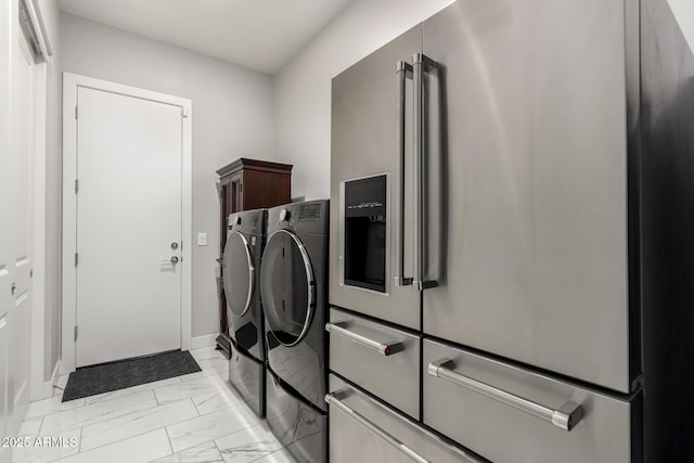 laundry area with baseboards, marble finish floor, cabinet space, and washer and dryer