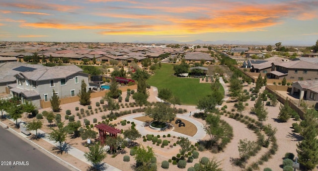 aerial view at dusk featuring a residential view