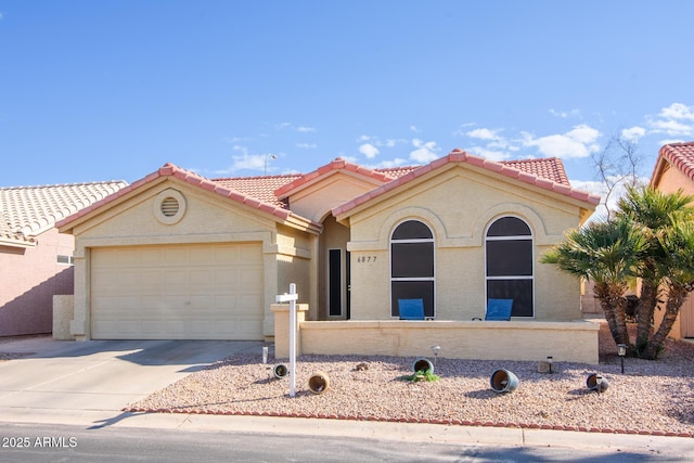 mediterranean / spanish-style home with a garage